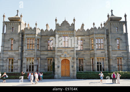 ALUPKA, RUSSIA - SEPTEMBER 28, 2014: tourists and front view of northern entrance facade of Vorontsov (Alupka) Palace in Crimea. Stock Photo