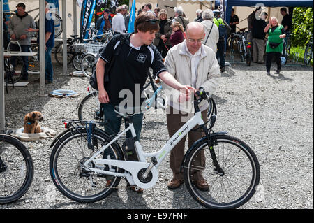 Presteigne, Powys, UK. Interested visitors at a demonstration of electric bikes Stock Photo