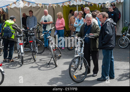 Presteigne, Powys, UK. Interested visitors at a demonstration of electric bikes Stock Photo