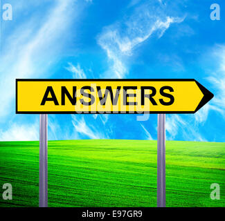 Conceptual arrow sign against beautiful landscape with text - ANSWERS Stock Photo