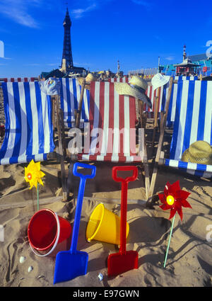 Seaside bucket and spades. Deckchairs and summer hats on Blackpool beach. Lancashire, UK Stock Photo