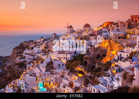 Windmill & white houses at sunset  in the village of Oia, Santorini, Thira, Cyclades Islands, Greek Islands, Greece, EU, Europe Stock Photo