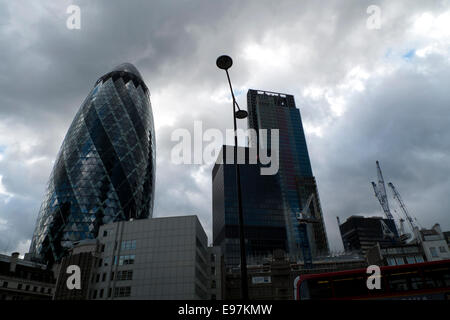 City of London UK. 21st October 2014. Dark storm clouds mix with patches of blue sky above the Gherkin at 30 St Mary Axe and the  Leadenhall or cheesegrater buildings on a severely windy day in autumn in the City of London. KATHY DEWITT/Alamy Live News