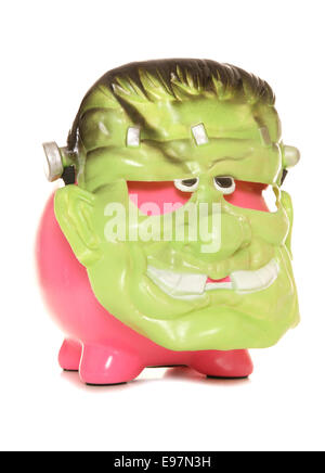 Piggy bank wearing a Frankenstein halloween mask cutout Stock Photo