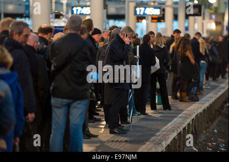 Manchester, UK.  21st October, 2014. The remnants of Hurricane Gonzalo caused considerable travel disruption to rail commuters across the United Kingdom, including those at Manchester Piccadilly. Some rail operators advised passengers to check services before setting off. Credit:  Russell Hart/Alamy Live News. Stock Photo