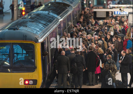 Manchester, UK.  21st October, 2014. The remnants of Hurricane Gonzalo caused considerable travel disruption to rail commuters across the United Kingdom, including those at Manchester Piccadilly. Some rail operators advised passengers to check services before setting off. Credit:  Russell Hart/Alamy Live News. Stock Photo