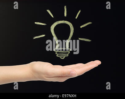 Hand with chalk lamp drawn on blackboard by hand not in photoshop Stock Photo