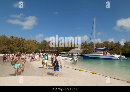 Tourists on the jetty, Ile aux Cerfs island, a small tropical holiday island just off the east coast, Mauritius, Africa Stock Photo