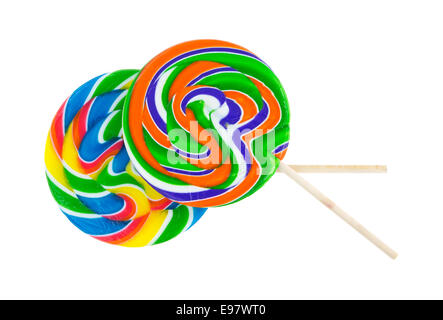 Two very colorful lollipops with wood stick handles on a white background. Stock Photo