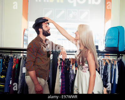 Young couple fooling around in clothing store Stock Photo