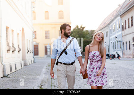 Happy young couple taking a walk in town