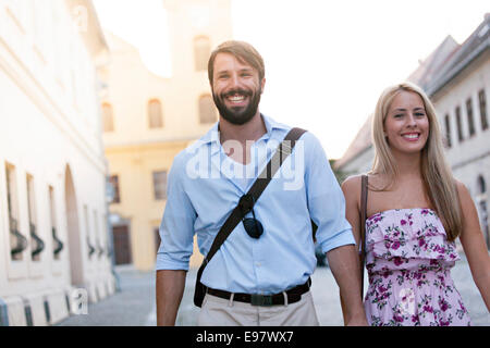 Happy young couple taking a walk in town