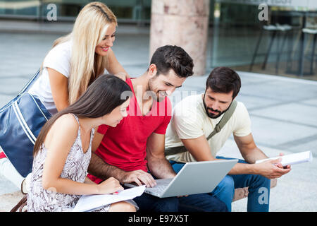 Group of students working together on laptop Stock Photo