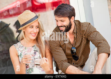 Happy young couple taking a break in town Stock Photo
