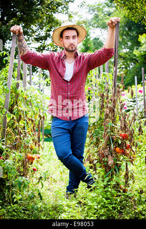 Portrait of young man in vegetable garden Stock Photo