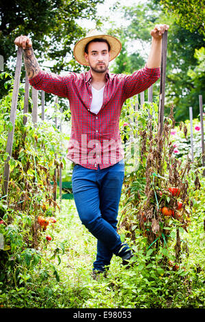 Full length portrait of a male gardener standing with a shovel isolated ...