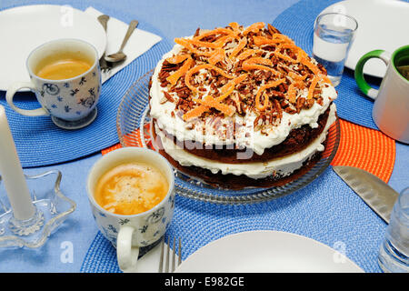 Blue circular place mats are set in geometric pattern irage placement in center. In center is fancy chocolate cake white Stock Photo