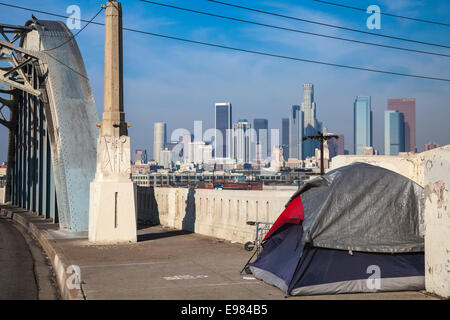 Tent of homeless person on 6th Street Bridge with Los Angeles skyline in the background. California, USA Stock Photo