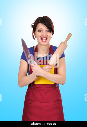 young housewife holding a rolling pin and knife Stock Photo