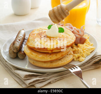 Breakfast of pancakes, syrup, eggs and sausage Stock Photo - Alamy
