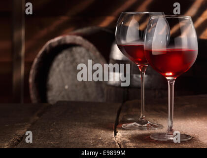 Two glasses of red wine on a table in a vintage beer cellar Stock Photo