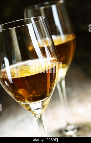 Two glasses of sherry on brown wooden background Stock Photo