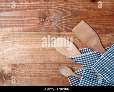 Three wooden spoons wrappen in a cloth on wooden surface Stock Photo