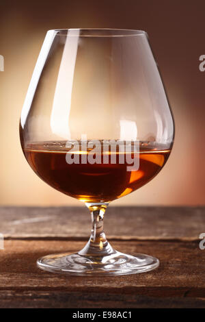 Glowing golden brown cognac served in a snifter as a luxury after dinner beverage Stock Photo