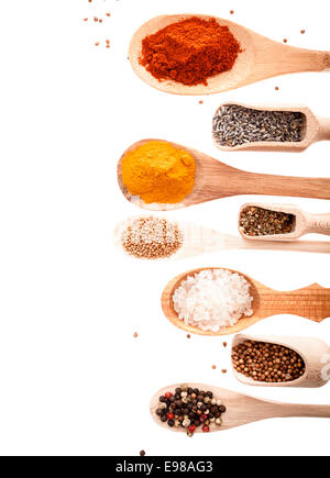 Overhead view of wooden scoops and spoons in different shapes and sizes filled with assorted spices and condiments isolated on white with copyspace Stock Photo