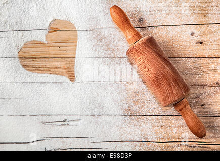 Flour, cookie cutters shaped as heart and rolling pin on a stone Stock  Photo by ©karidesign 107741166