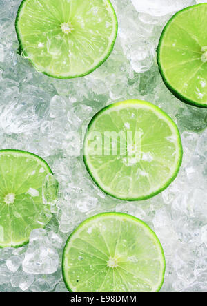 Close-up of five fresh slices of green limes over crushed ice cubes Stock Photo