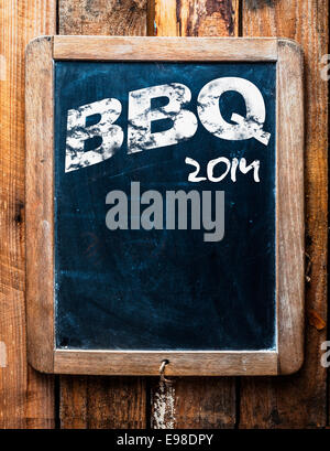 Old grunge BBQ advertising sign on an old school slate board with a distressed wooden frame and copyspace for your text mounted Stock Photo