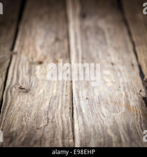 Background of old weathered wooden boards with a diminishing perspective and shallow dof in square format