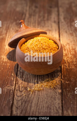 Earthenware pot of bulgur wheat, a form of cracked or dried crushed wheat granules or grains used in Middle Eastern cuisine Stock Photo