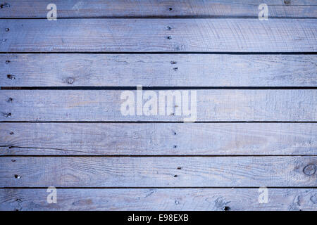 Textured wooden board background in a 2014 fashion color of a pastel shade of blue with rows of small nails and parallel planks Stock Photo