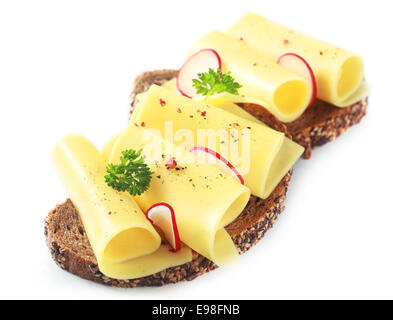 Delcious rolled slices of golden gouda cheese on a wholewheat sandwich garnished with sliced radish and parsley on a white background Stock Photo