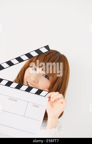 Half length portrait of young Japanese woman against white background Stock Photo