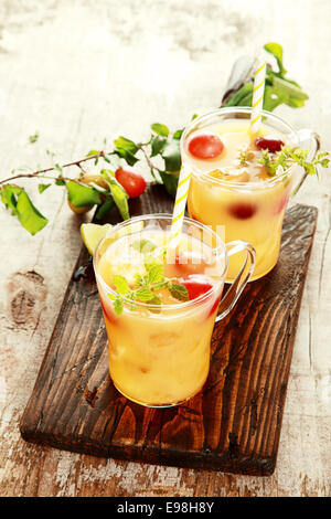 Two Healthy Delicious Fruit Juices on Wooden Table. Good for Detoxifying. Stock Photo