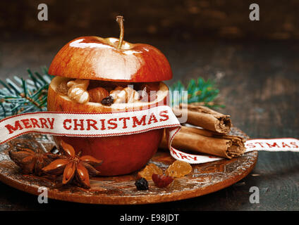 Red Christmas Apple with Anise, Lace and Cinnamon Stick on Round Pltaform Stock Photo