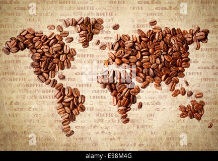 Fresh roasted coffee beans arranged in the shape of a world map on aged vintage paper with the word coffee in multiple languages. Stock Photo