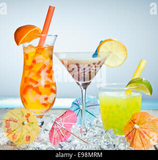 Three different boba tea cocktails with mango, orange, coffee and lime flavored. With paper umbrellas. Stock Photo