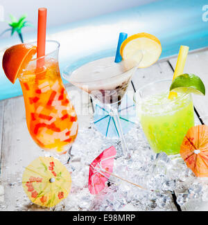 Three different colourful tropical fruit bubble tea sorts served chilled on a bed of crushed ice as a welcome refreshment at a beachfront resort Stock Photo