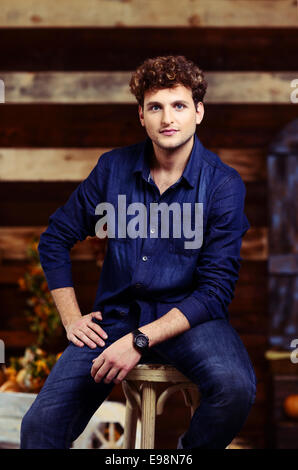 Portrait of a handsome man sitting on the chair Stock Photo