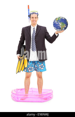 Full length portrait of a businessman with diving mask holding the earth and standing in a small pool Stock Photo