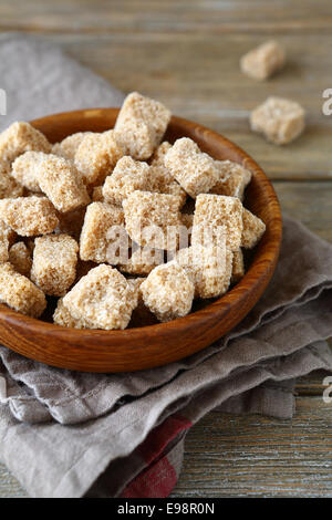Brown sugar in a wooden bowl, side view Stock Photo