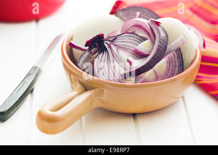 chopped onion in ceramic pan Stock Photo