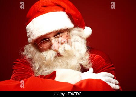 Smiling Santa Claus in eyeglasses posing for camera Stock Photo