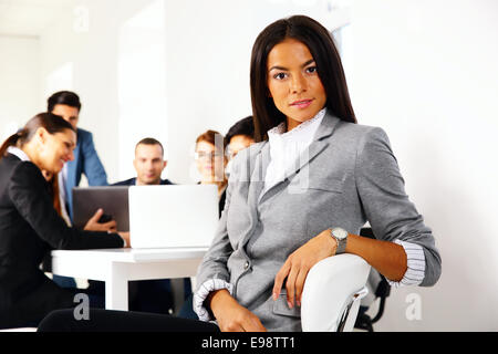 Businesswoman sitting on the office chair in front of business meeting Stock Photo