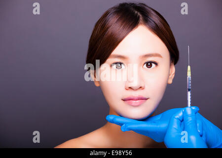 asian beautiful woman gets injection in her face. Stock Photo