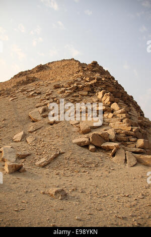 The Pyramid of Nyuserre Ini built in the necropolis of Abusir, Egypt. He was an Ancient Egyptian pharaoh, the sixth ruler of the Fifth Dynasty during the Old Kingdom period. He is frequently given a reign of 24 or 25 years and is dated from ca. 2445 BC to 2421 BC. His prenomen, Nyuserre, means 'Possessed of Re's Power'. Nyuserre was the younger son of pharaoh Neferirkare Kakai by Queen Khentkaus II, and the brother of the short-lived king Neferefre. Stock Photo